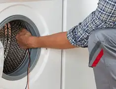 Dryer repair technician diagnosing and servicing a clothes dryer in Mesa, AZ