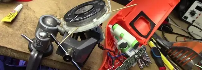 Vacuum cleaner repair parts and tools on a workbench in Mesa, AZ