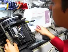 Vacuum repair technician servicing internal components on a workbench in Mesa, AZ