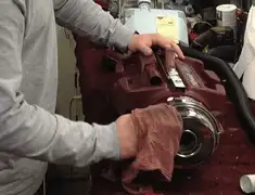 Vacuum repair technician cleaning and servicing a vacuum motor in Mesa, AZ