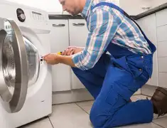 Washing machine repair technician servicing a front-load washer in Mesa, AZ